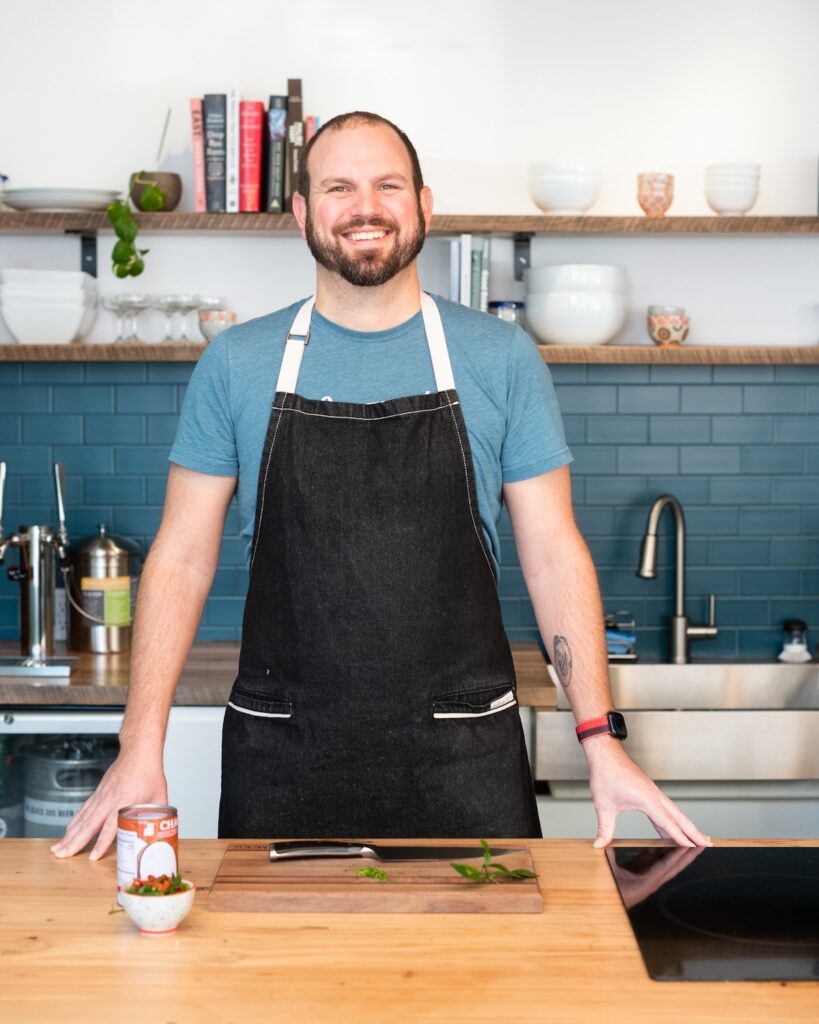 Picture of Nathan in an apron in the Current Wellness kitchen